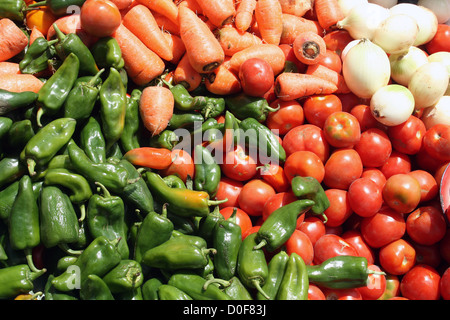 Les poivrons, les tomates, les carottes et les oignons sont certains des légumes pour la vente au marché de l'alimentation extérieure à Otavalo, Equateur Banque D'Images