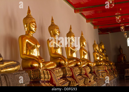 Thaïlande - Bangkok, Wat Phra Kaeo, Temple Grand Palais, rangée de statues de Bouddha en or. Banque D'Images