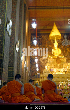 Moines priant dans Phra Ubosot Hall, temple Wat Pho à Bangkok, Thaïlande Banque D'Images