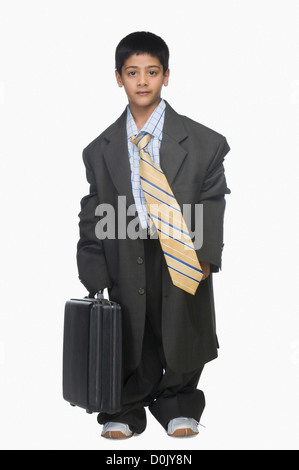 Portrait of a Boy wearing oversized costume et holding briefcase Banque D'Images