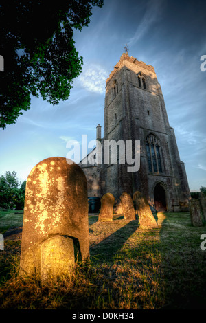 Partie de la 14e siècle tower de wisbech St Mary church avec pierres tombales. Banque D'Images