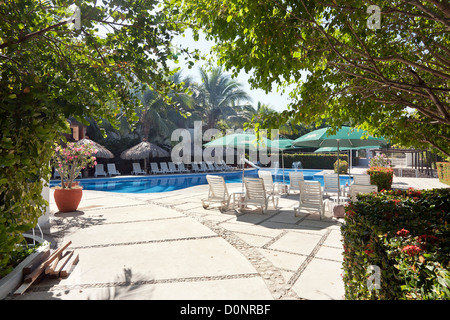 Abri piscine avec patio en plastique chaises longues de plage privée à Bahia de Chahue Huatulco Mexique Banque D'Images
