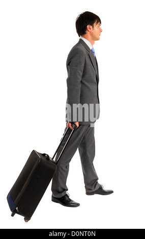 Young business man walking avec son chariot sac sur fond blanc Banque D'Images