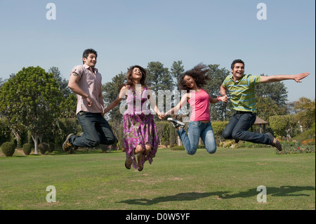 Bénéficiant d'amis dans un jardin Banque D'Images