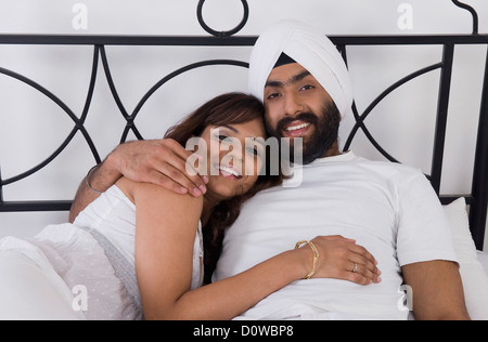 Couple Sikh allongé sur le lit Banque D'Images