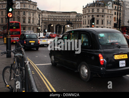 Les véhicules circulant autour du rond-point, à Trafalgar Square, Londres. L'Admiralty Arch dans l'arrière-plan Banque D'Images