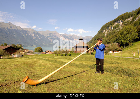 Cor des Alpes, l'homme, de cors, de la soufflante, champ, de la tradition, de l'Oberland bernois, Iseltwald, canton de Berne, Suisse, Europe, Banque D'Images