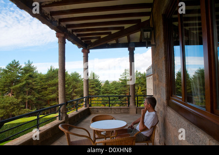 Homme assis sur une terrasse du Parador de Gredos. Navarredonda de Gredos, Avila province, Castilla Leon, Espagne. Banque D'Images