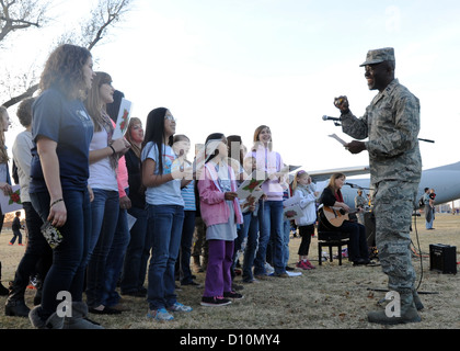 ALTUS AIR FORCE BASE, en Oklahoma - Bedemoore Udechukwu, 97e Escadre, aumônier de la mobilité aérienne chante Noël avec la chorale catholique avant d'allumer l'arbre de Noël à base de Wings of Freedom Park, le 30 novembre 2012. Les membres d'Altus AFB réunies au parc Banque D'Images