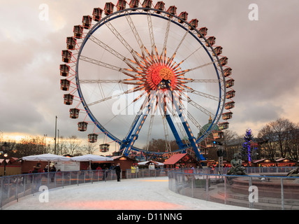 Patinoire et grande roue à un marché de Noel dans la soirée à Alexanderplatz, Berlin, Allemagne Banque D'Images