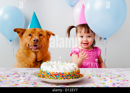 Girl and dog celebrating birthday Banque D'Images