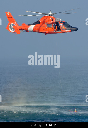 HERMOSA Beach, Californie, le Maître de 1re classe Aweau Ty, une survie de l'Aviation, technicien procède à la formation d'un nageur-sauveteur avec un équipage de la Garde côtière Station Air Los Angeles au large de l'Hermosa Beach Pier, Novembre 31, 2012. Les équipages doivent constamment tr Banque D'Images