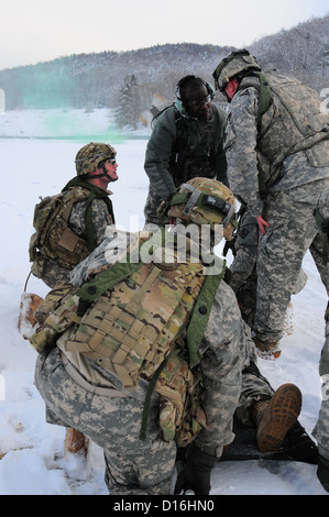 Les soldats de l'Armée américaine à partir de la 541e compagnie du génie parler à chef de l'équipe de Sgt. 1re classe Christopher Rowley sur les procédures d'évacuation médicale d'une victime simulée pendant un exercice d'entraînement situationnel (STX) au Centre de préparation à l'interarmées multinationale Banque D'Images