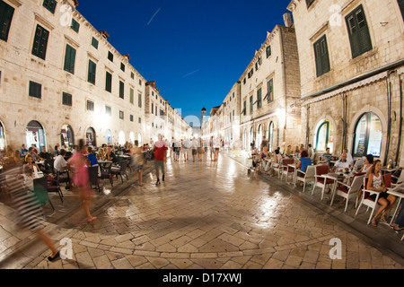 Les piétons marcher la nuit le long de la rue principale Stradun, dans la vieille ville de Dubrovnik, sur la côte Adriatique de Croatie. Banque D'Images