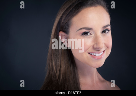 Young Beautiful woman smiling on black background Banque D'Images