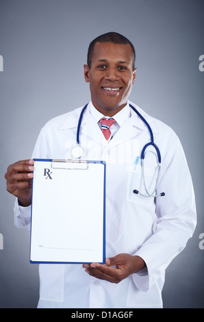 Portrait of smiling doctor showing blank prescription Banque D'Images