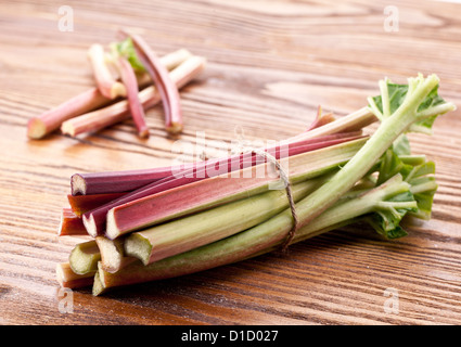 Les tiges de rhubarbe sur une table en bois. Banque D'Images