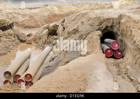 Les fils des câbles d'électricité avec tube de protection mises de l'industrie de la construction de la communication souterraine. Banque D'Images