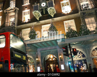 Magasin Fortnum & Mason dans la nuit avec un bus rouge de Londres typique en premier plan London UK 2012 Noël Banque D'Images