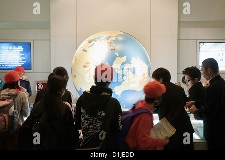 Les écoliers japonais se réunir autour d'un affichage dans le Musée Mémorial de la paix à Hiroshima Banque D'Images