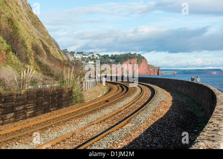 Teignmouth, Devon, Angleterre. 24 décembre 2012. Vue de la ligne de chemin de fer Brunel à Teignmouth avec les rochers et mer mur. Banque D'Images