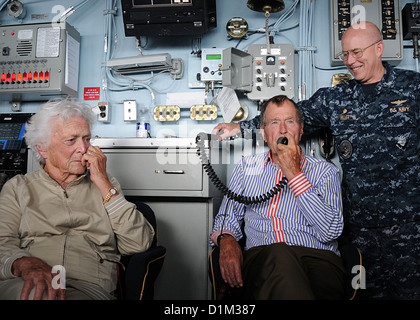 L'ancien président George H. W. Bush, centre, adresses des marins américains via le système lors d'une visite au porte-avions USS George H. W. Bush (CVN 77) dans l'Océan Atlantique le 14 janvier 2010. Bush d'accompagnement sont épouse Barbara Bush, à gauche, une Banque D'Images