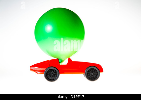 Petite voiture, alimenté par l'air d'un ballon explosé. L'air effluent conduit la voiture de l'avant. Image symbole, puissance alternative. Banque D'Images