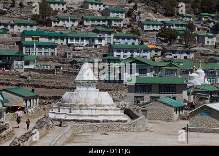 Les randonneurs à pied passé le Gompa Blanc et Stoupa dans le village de Népalais près de Khumjung, marché de Namche Nepal Banque D'Images