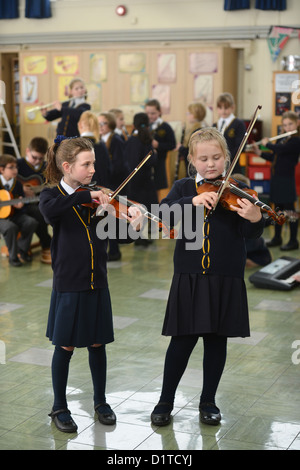 Deux jeunes filles jouant du violon dans une leçon de musique Notre Dame et St Werburgh's Catholic Primary School à Newcastle-under-Lyme, Staffords Banque D'Images