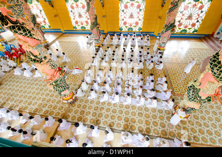 Fidèles à la prière de midi dans le temple de Cao Dai, Tay Ninh, Vietnam, Asie Banque D'Images