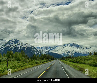 29 juin 2012 - péninsule de Kenai, Alaska, États-Unis - Approche d'une imposante chaîne de montagnes enneigées au volant du sud sur l'autoroute de Seward pittoresque dans la forêt nationale de Chugach. Une forêt nationale désignée Scenic Byway, un All-American Road et un Scenic Byway, l'ALASKA Seward Highway exécute 127 miles [204 km] de mouillage à Seward à travers la péninsule Kenai Chugach State Park, la Forêt Nationale de Chugach, et une vitrine de la beauté naturelle et la diversité des paysages dans le centre-sud de l'Alaska. (Crédit Image : © Arnold Drapkin/ZUMAPRESS.com) Banque D'Images