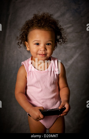 Studio Portrait of a cute baby girl, 18 mois, de race mixte Banque D'Images