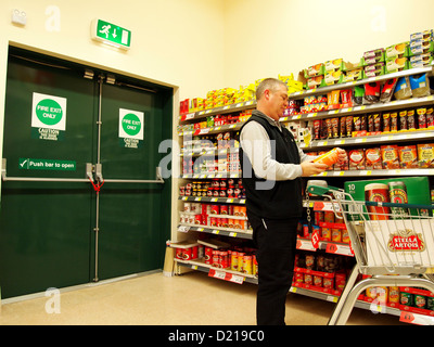 À l'intérieur d'un supermarché anglais moderne dans la région de Weston super Mare, en Angleterre, avec un nouveau client & étagères ensemencés. Janvier 2013 Banque D'Images