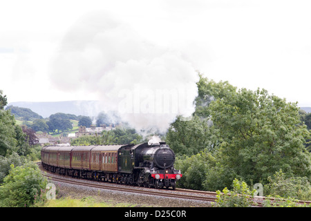 Locomotive à vapeur tirant un train de voyageurs sur la ligne principale près de régler Banque D'Images