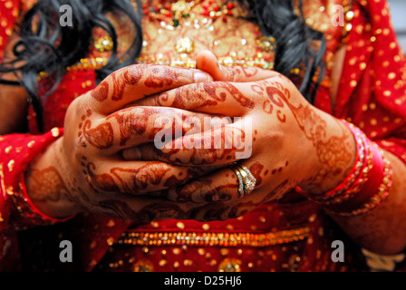 Asian bride le jour de son mariage en costume traditionnel et mains peint avec le henné, Hounslow, Middlesex, Royaume-Uni. Banque D'Images