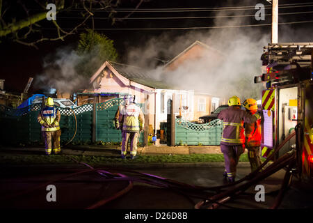 Les pompiers s'attaque à un brasier dans un bungalow qui a pris feu après que la chaudière a explosé dans la cuisine. Banque D'Images