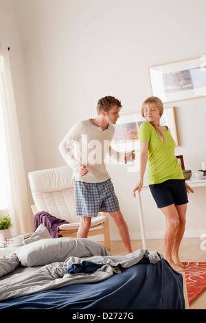 Couple dancing in bedroom Banque D'Images
