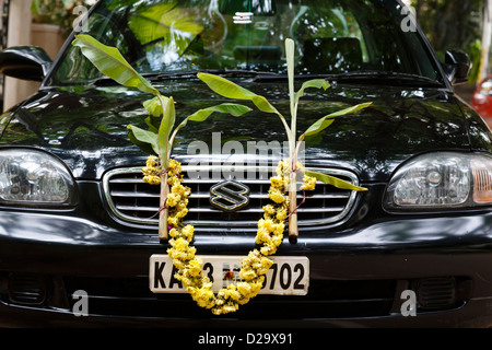 Une voiture de Maruti Suzuki est décorée de fleurs et de feuilles de bananier pour la cérémonie hindoue de Dussehra, Bangalore, Inde Banque D'Images