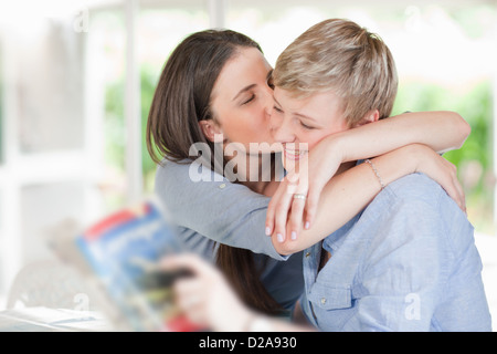 Woman kissing smiling girlfriend Banque D'Images