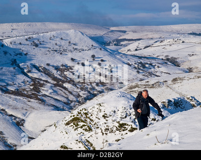 Walker hiver sur Chrome Hill dans le Peak District, la région de Dove Valley et au-delà du bord Ax Banque D'Images