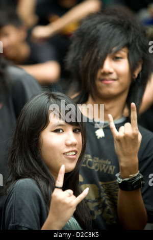 Les adolescents en attente de l'ouverture d'un club d'assister à un concert de rock, à Bangkok, Thaïlande Banque D'Images