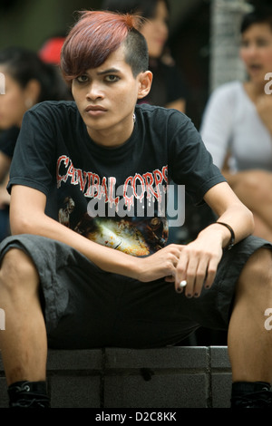 Les adolescents en attente de l'ouverture d'un club d'assister à un concert de rock, à Bangkok, Thaïlande Banque D'Images