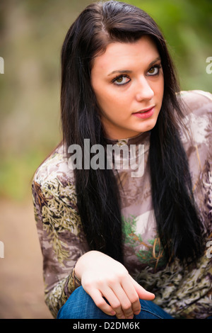 Portrait d'une adolescente en plein air, 18 ans, de race blanche, en jeans et pull camouflage Banque D'Images