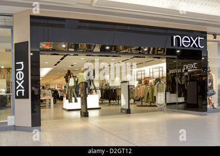 Panneau du magasin de vêtements d'affaires Next plc et entrée ouverte depuis un centre commercial intérieur Thurrock Essex Lakeside, Angleterre, Royaume-Uni Banque D'Images