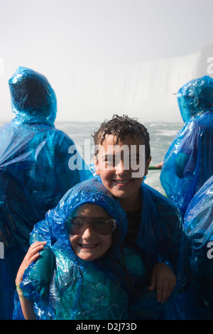 Les enfants dans des imperméables à bord du Maid of the Mist excursion en bateau dans la région de Niagara Falls, Canada Banque D'Images