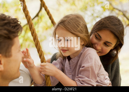 Close up of family on swing Banque D'Images