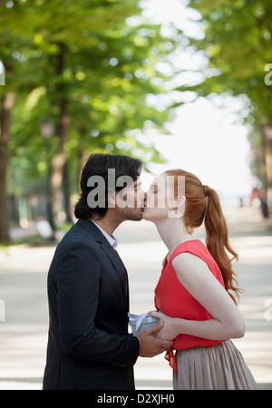 Couple kissing in park Banque D'Images