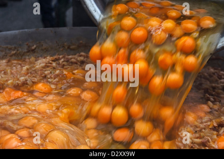 Oeufs cassés, verser dans un grand bol et mélanger avec couverts en bois, de faire une omelette géante. Banque D'Images