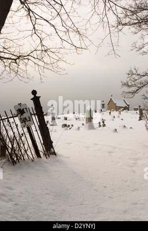 Creepy cimetière de malheur, un jour d'hiver, avec sortie seule signe. Banque D'Images