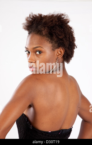 Lovely black woman looking over her shoulder with a thoughtful and